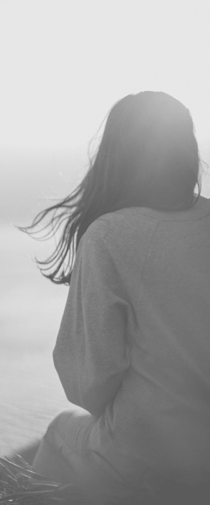 woman looking out at the ocean