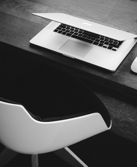 partially closed laptop on desk